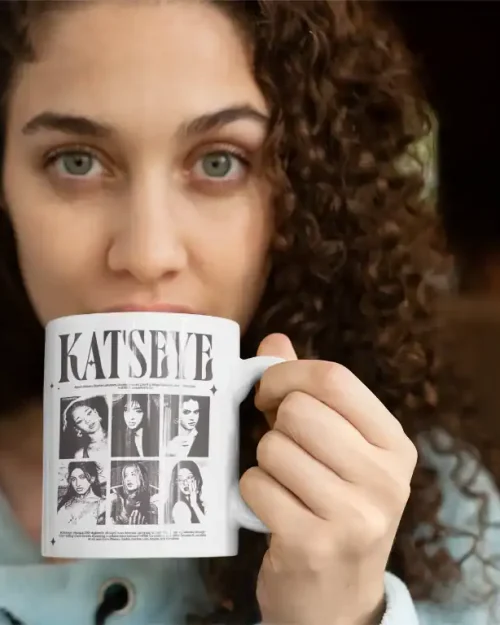 green eye girl sipping coffee from white ceramic katseye mug